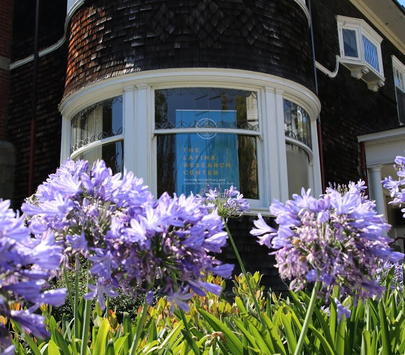 Latinx Research Center House with purple flowers surrounding.